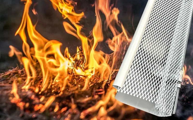 Steel mesh gutter guard in front of flames, showing bushfire ember protection
